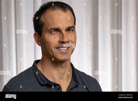 mature man 44 years old in photo session with dark blue polo shirt making several faces stock