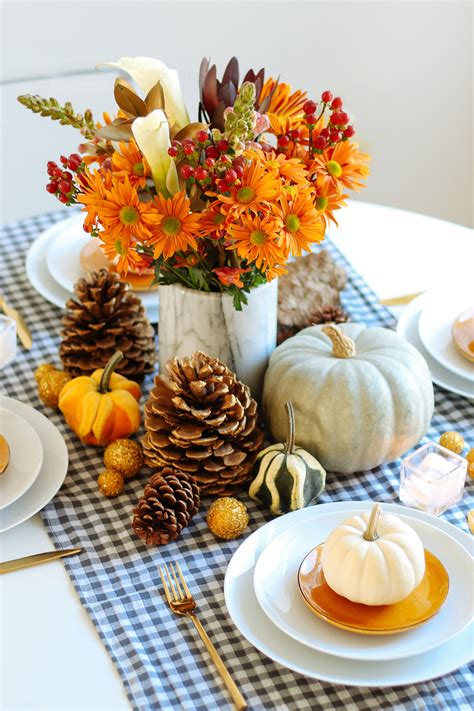 A gold and amber thanksgiving arrangement with lights, leaves, wheat and pumpkins is a beautiful decoration. 18 Thanksgiving Centerpieces - Thanksgiving Table Decor