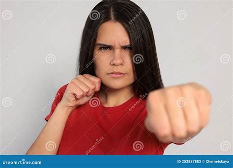 Young Woman Ready To Fight On Light Grey Background Stock Image Image