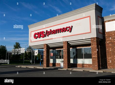 A logo sign outside of a CVS Pharmacy retail store location in