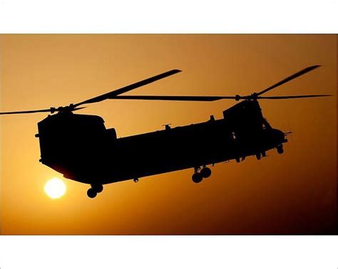 Prints Of A Raf Chinook Helicopter Takes Off On A Dawn Mission Over