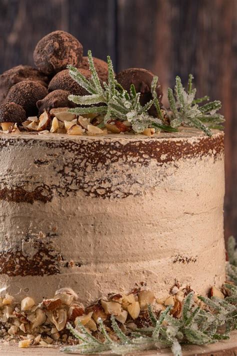 Delicious Naked Chocolate And Hazelnuts Cake On Table Rustic Wood