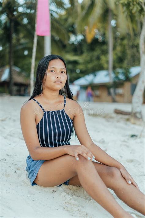 portrait of a beauitful brown skin filipina model on a white sand beach in the philippines stock