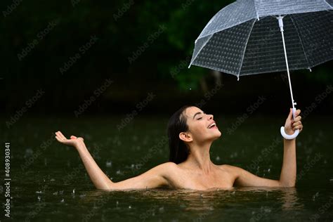 Naked girl with umbrella Raining flood Autumn time ภาพถายสตอก