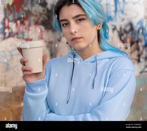 Teenage Girl In Light Blue Oversize Hoodie With Coffee To Go And
