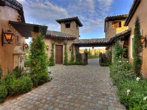 The Exterior Of This Spacious Old World Home Has A Cobblestone Walkway