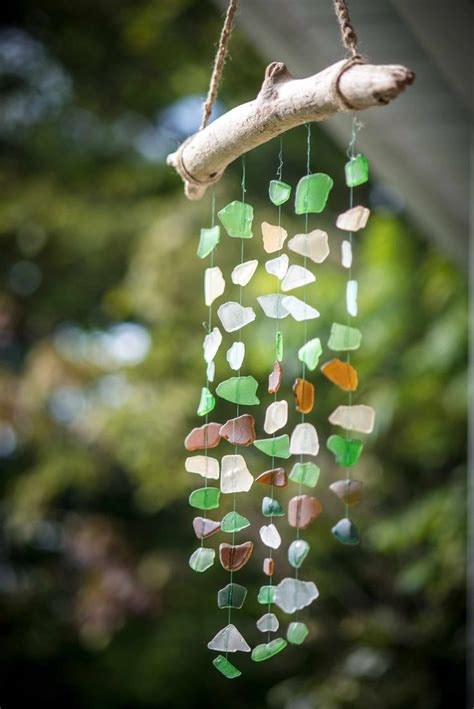 A Wind Chime Hanging From A Tree Branch With Sea Glass On It S Side