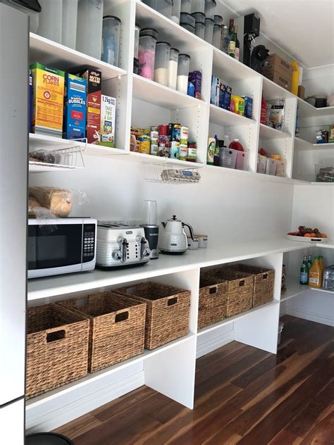 A corner pantry with an angled door maximizes storage space in the kitchen. We added some shelves to our walk-in-pantry | Pantry room ...