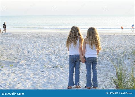 Sisters Holding Hands At The Beach Royalty Free Stock Photo
