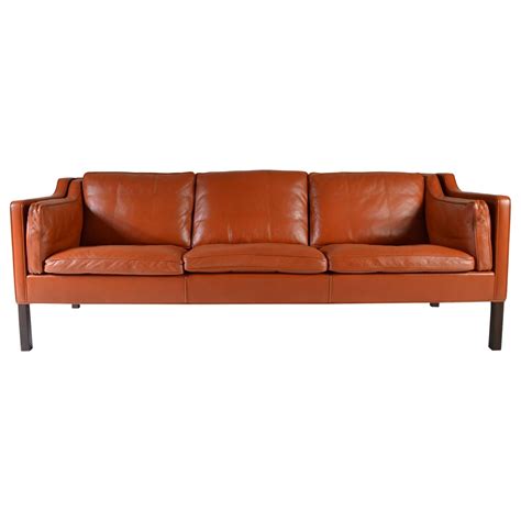 This futuristic couch features adjustable headrests and storage space at both ends of the sectional, perfect for books or decorative items. Cognac Leather Sofa by Børge Mogensen for Fredericia ...