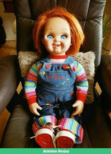 A Doll With Red Hair Sitting In A Chair