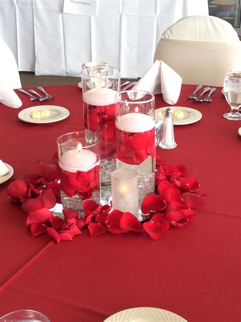 Triple Cylinder Vases With Floating Candles And Red Rose Petals