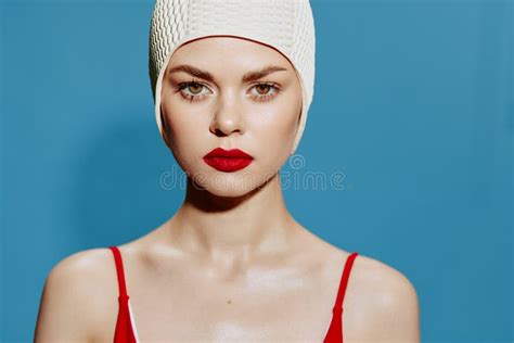 Serious Tense Woman In Swimming Cap Red Swimsuit On Blue Background Looking At Camera Stock