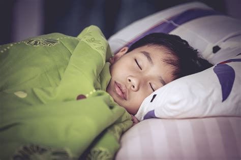 Healthy Child Little Asian Boy Sleeping Peacefully On Bed Stock Photo