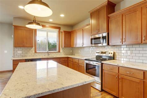 Stained Cabinets With A Subway Backsplash Floridatile Streamline And