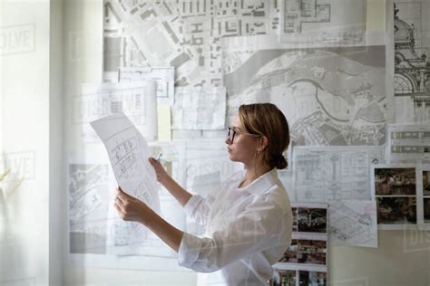 Smart Architect Examining Draft During Work Stock Photo Dissolve