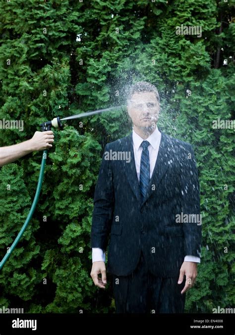 Man Getting Sprayed In The Head With A Hose Stock Photo Alamy