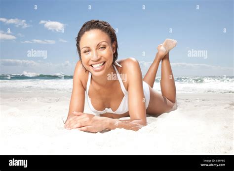 Portrait Of A Smiling Woman Lying On Beach Sunbathing Cape Town