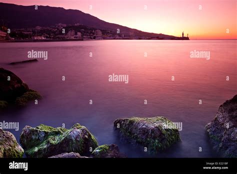 Rocky Beach Sunrise Over Sea Stock Photo Alamy