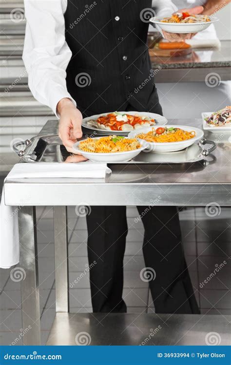 Waiter Placing Pasta Dishes On Tray Stock Photo Image Of Midsection