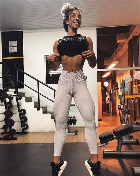 A Woman Standing In Front Of A Gym Machine