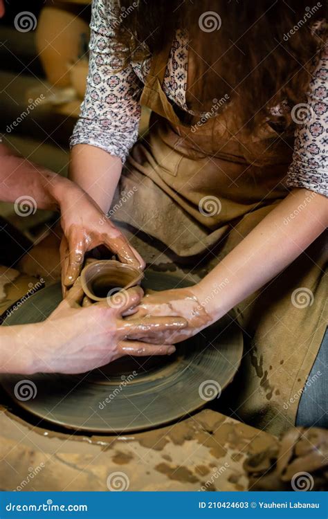 Pottery Classes Student Making Clay Pot On Wheel Close Up Of Dirty