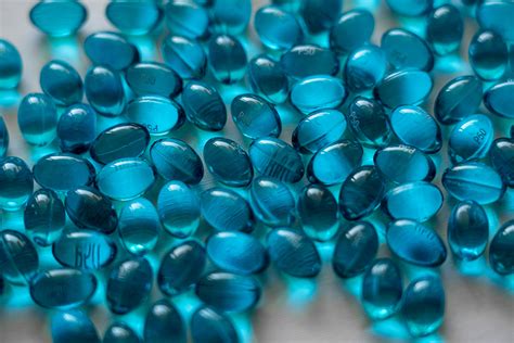 Blue Gel Capsules On Table · Free Stock Photo