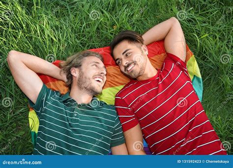 Happy Gay Couple Lying On Green Grass Stock Image Image Of Green