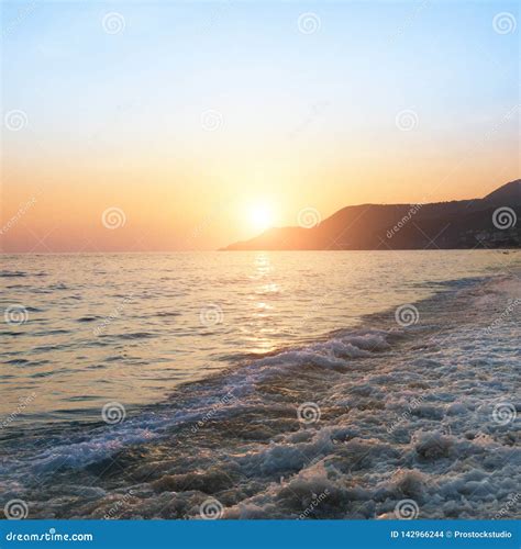 Beautiful Sunrise Over Sea And The Beach With Clear Sky Stock Photo