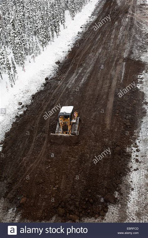 Bulldozer Plowing Snowy Dirt Road Stock Photo Alamy