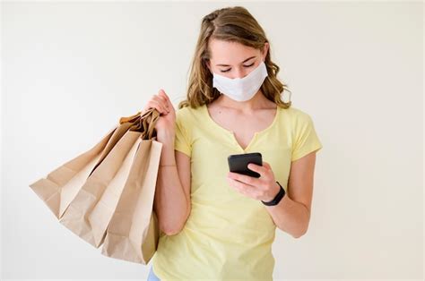 Free Photo Portrait Of Woman Holding Shopping Bags