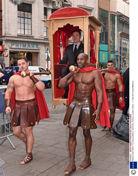 Shirtless Male Gladiators Carry David Walliams In Sedan Chair For BGT