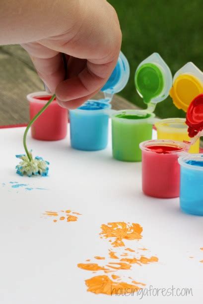 Looking for toddler painting ideas but worried your little one will eat more paint than she gets on the paper? Painting with Flowers | Housing a Forest