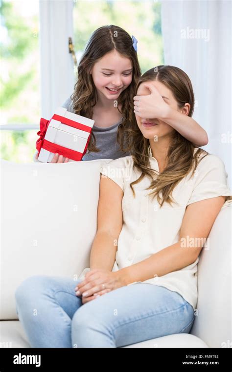 Daughter Covering Eyes Of Mother For Surprise T Stock Photo Alamy