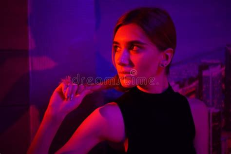 Young Beauty Woman Posing Over Night City Dramatic Red And Blue Neon Background Stock Image
