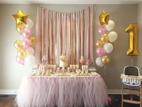 A Pink And Gold 1st Birthday Party With Balloons Cake Cupcakes And
