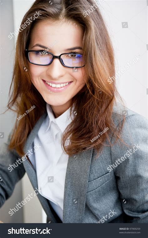 Beautiful Young Business Woman Wearing Glasses Sitting Relaxed At Her Office And Looking At