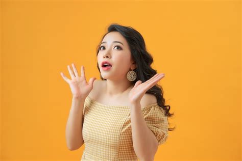 Premium Photo Surprised Young Woman Shouting Over Yellow
