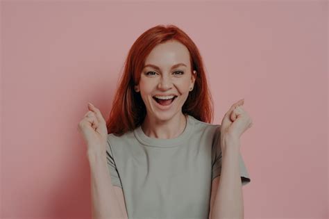 Premium Photo Young Overjoyed Redhead Woman Raising Hands Up With