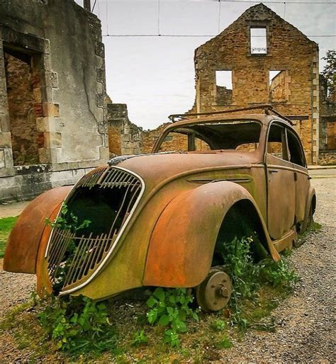 Decayed Peugeot 202 And Some Buildings In Oradour Sur Glane France