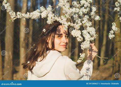Portrait Of Young Beautiful Woman Among Flowering Trees Fashion And