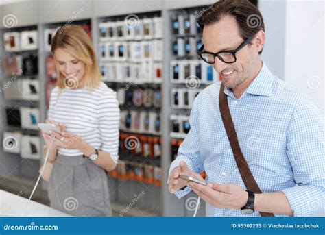 Smiling People Buying Smartphones At Electronics Shop Stock Image