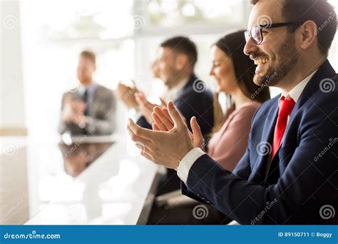 Smiling Business Group Clapping Hands At The Meeting Stock Image