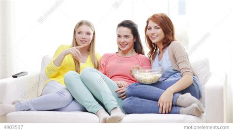 Three Smiling Teenage Girls Watching Tv At Home Stock Video Footage