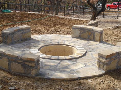 The fire pit is laid out to be centered to the existing pear tree and the window of the house. DRC Retaining Walls & Fences - STONE GALLERY
