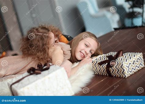 Two Pretty Sisters Are Having Fun In A Cozy Living Room Stock Image