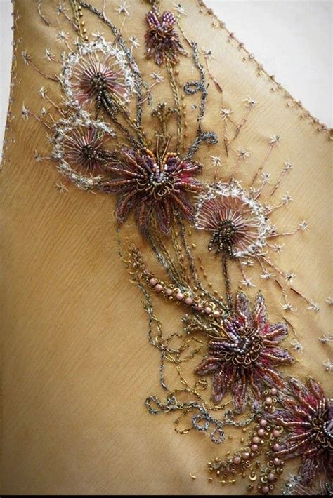 The Back Of A Dress With Beaded Flowers On It
