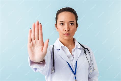 Premium Photo Portrait Of A Young Woman Doctor Posing Isolated Over