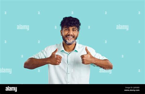 Portrait Of Happy Cheerful Young Indian Man In Shirt Showing Thumbs Up