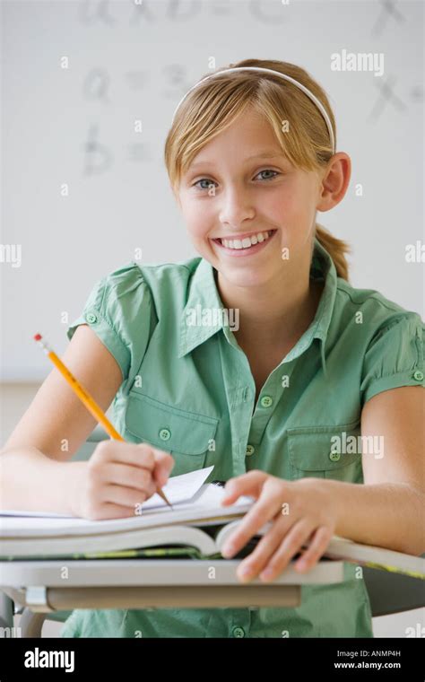 Teenaged Girl Writing At School Desk Stock Photo Alamy